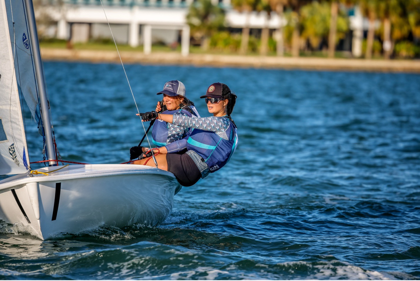 Sophie doing jib and tactics duty on a Flying Junior during a college regatta